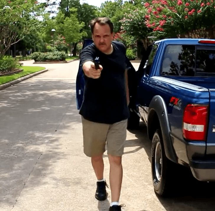 Simulator scenario: armed subject near a pickup truck in a residential driveway